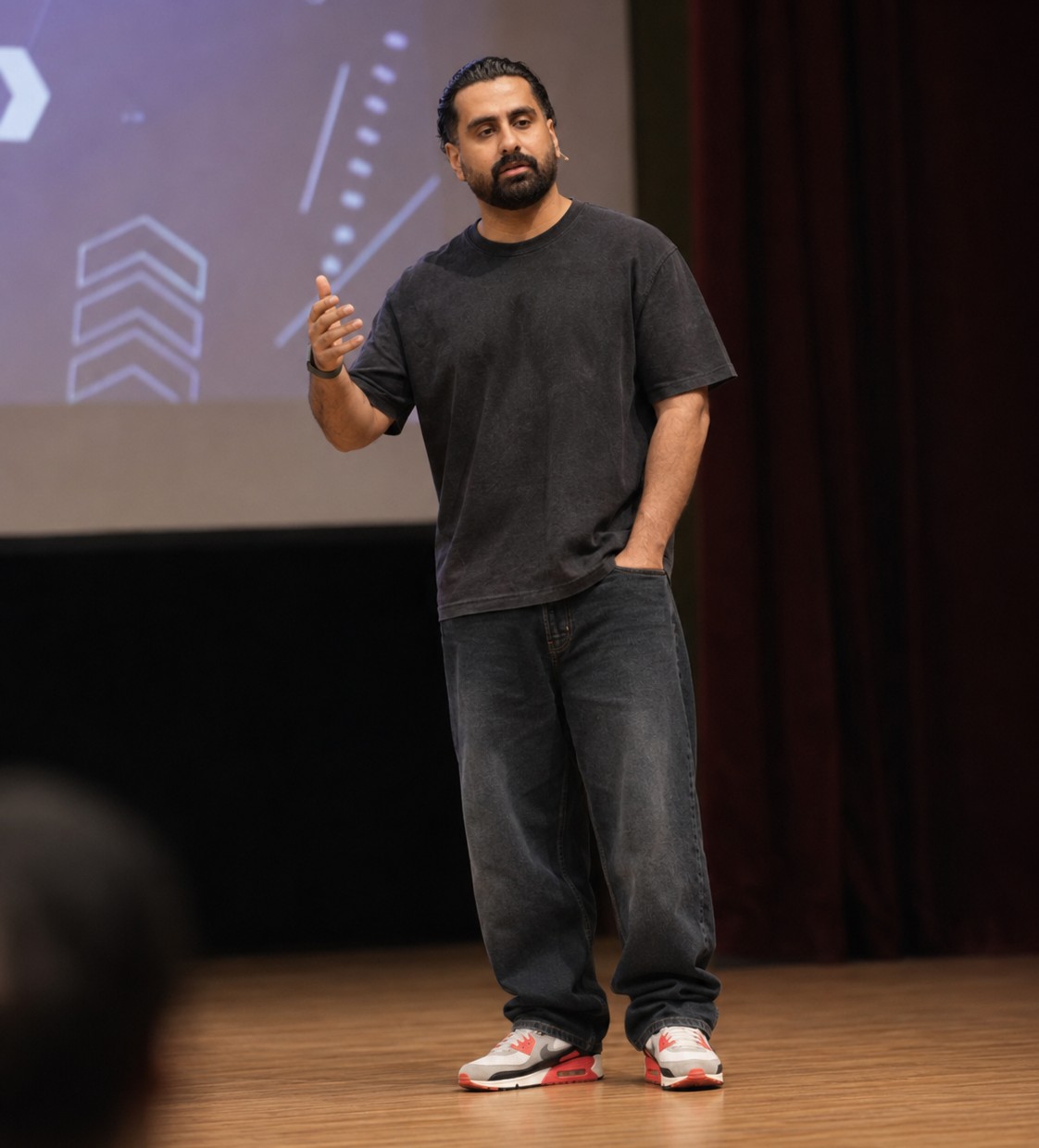 Zeeshan Ahmad speaking on stage